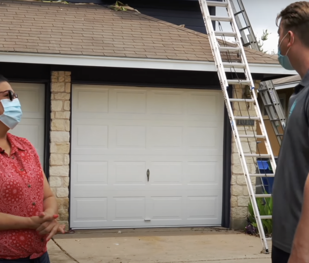 People talking in front of the garage